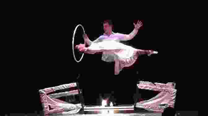 A Captivating Image Of An Illusionist Performing A Levitation Trick, With A Look Of Amazement On The Audience's Faces. How To Be An Illusionist: A Fundamental Guide To Performing A Modern Illusion Show