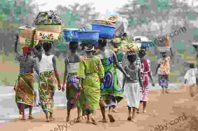 A Group Of People Walking Through A Rainforest, Carrying Baskets On Their Heads People Of The Rainforest: The Villas Boas Brothers Explorers And Humanitarians Of The Our Book Library