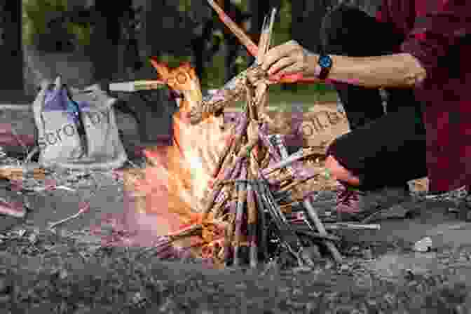 Image Of A Person Building A Fire The Unofficial Hunger Games Wilderness Survival Guide